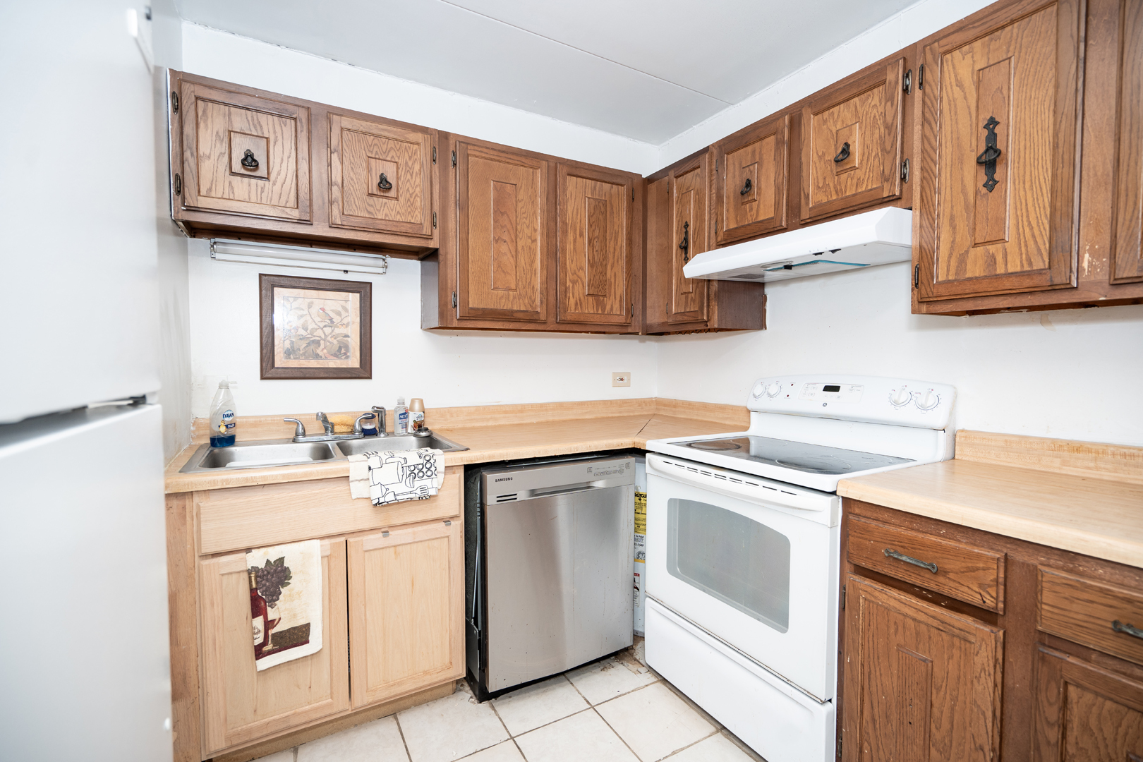 17005 Albany Avenue, Unit 202 Hazel Crest, IL 60429 - Photo 8 of 15 a kitchen with white cabinets sink and stove