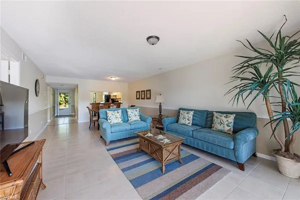 a living room with furniture flat screen tv and a table