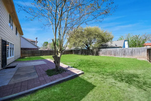 a view of a garden with a house