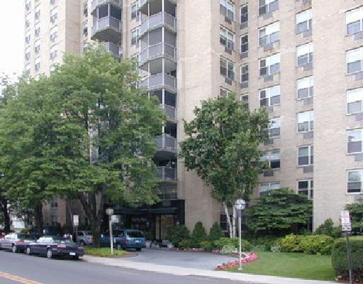 50 Glenbrook Road, Unit 11H Stamford, CT 06902 - Photo 1 of 1 view of a building and trees in front of it