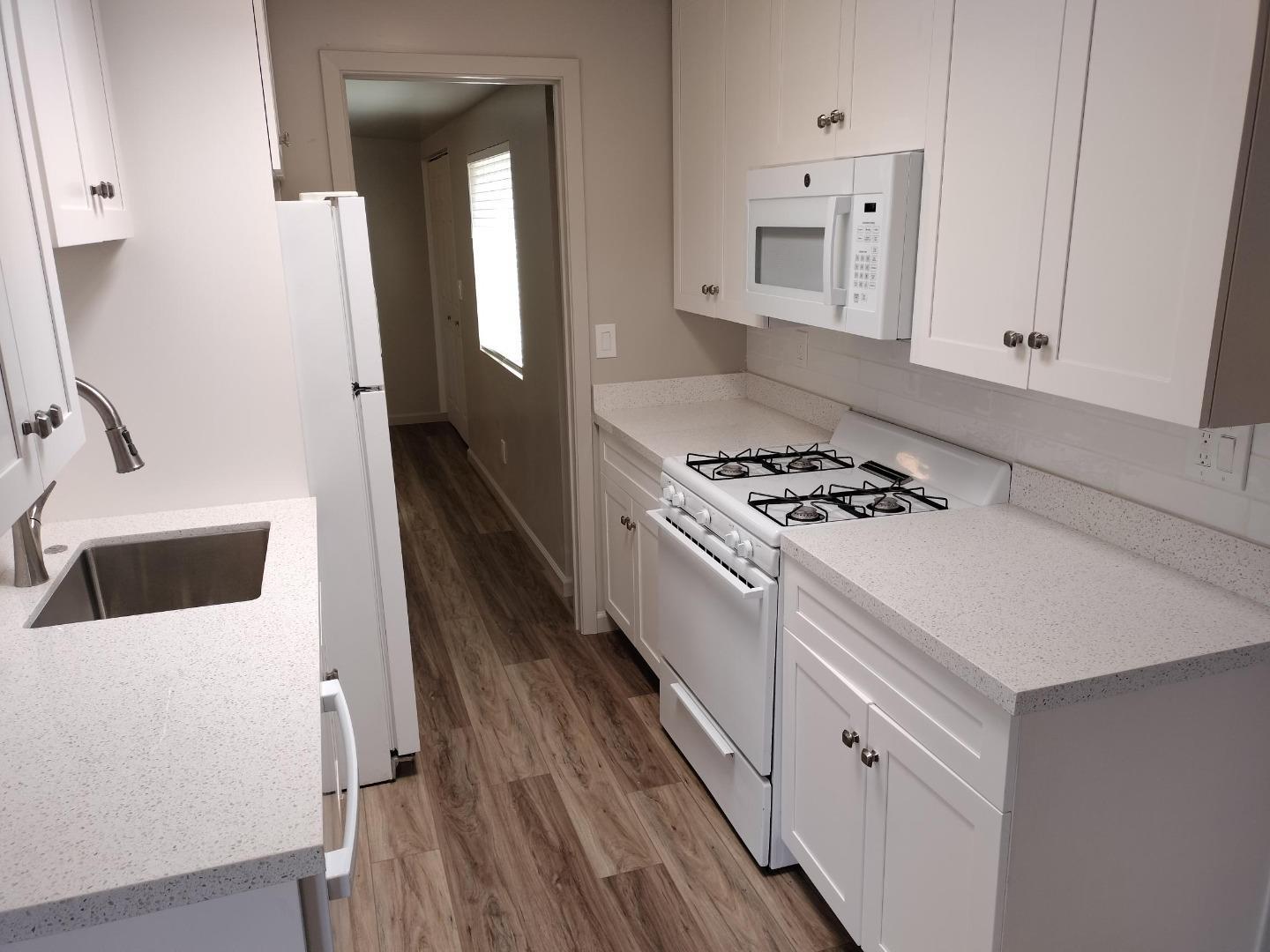413-415 Dela Rosa Avenue Monterey, CA 93940 - Photo 16 of 22 a kitchen with a white cabinets and white appliances