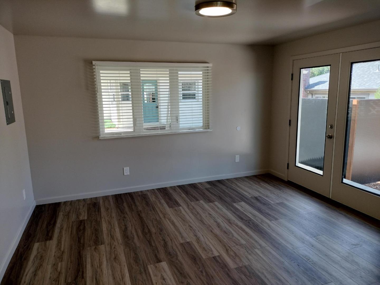 413-415 Dela Rosa Avenue Monterey, CA 93940 - Photo 18 of 22 an empty room with wooden floor and windows