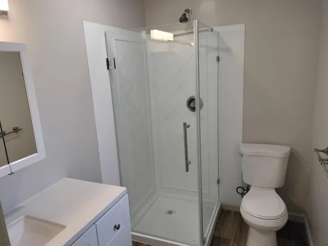 a white toilet sitting next to a bathroom sink