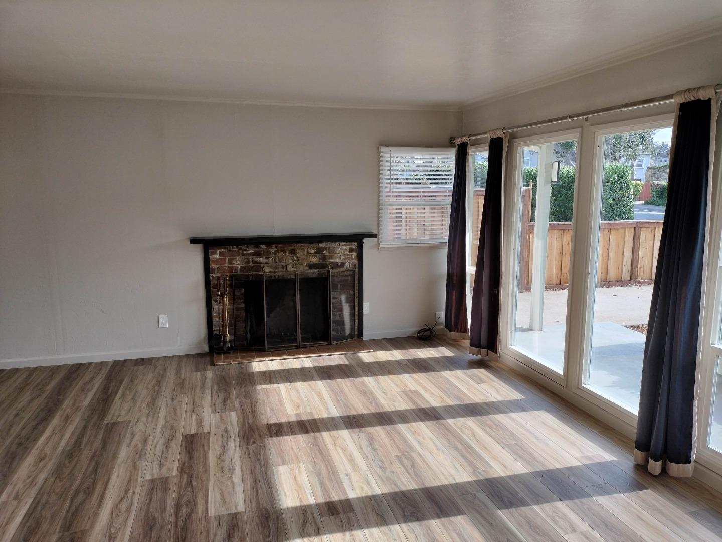 413-415 Dela Rosa Avenue Monterey, CA 93940 - Photo 2 of 22 a view of an empty room with glass door and windows