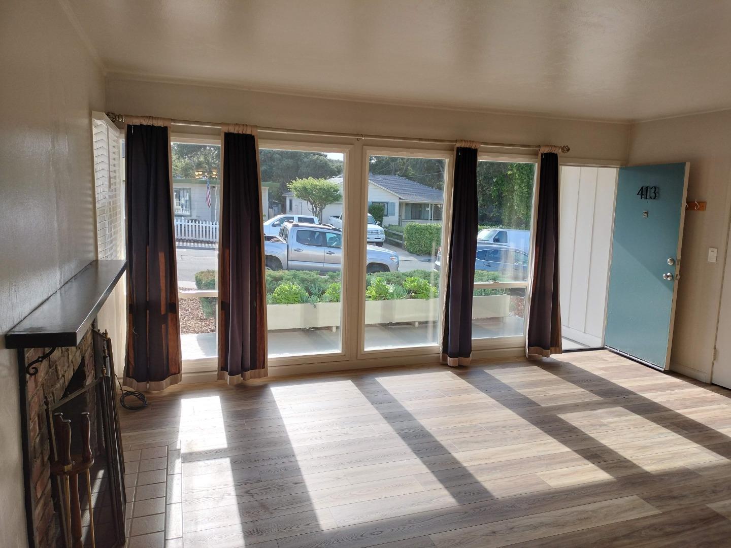 413-415 Dela Rosa Avenue Monterey, CA 93940 - Photo 3 of 22 a view of a room with large windows and a patio