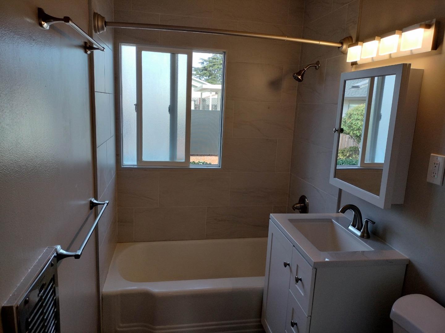 413-415 Dela Rosa Avenue Monterey, CA 93940 - Photo 6 of 22 a bathroom with a granite countertop sink toilet and shower