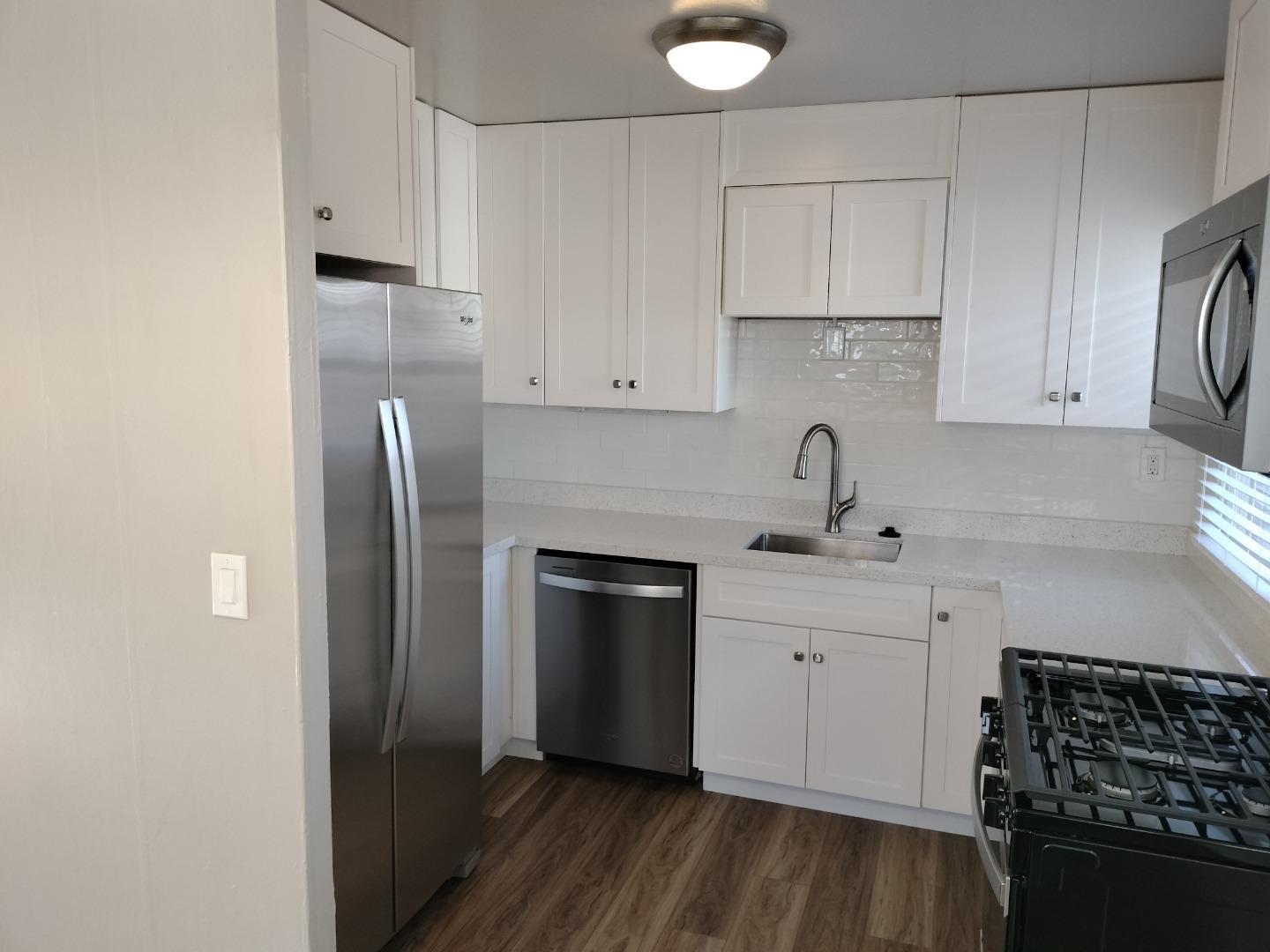 413-415 Dela Rosa Avenue Monterey, CA 93940 - Photo 9 of 22 a kitchen with stainless steel appliances a refrigerator sink and cabinets