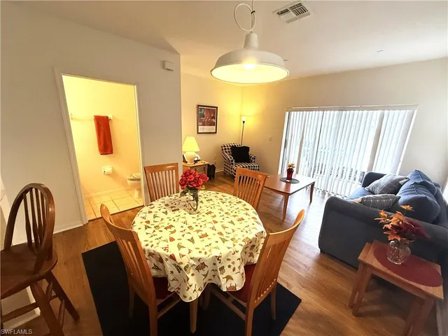a view of a dining room with furniture and a chandelier