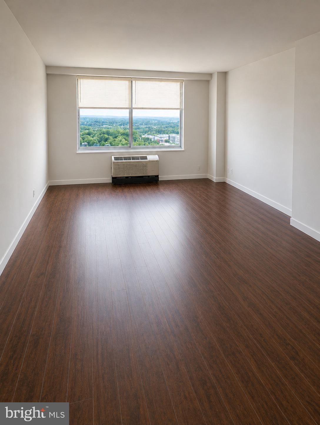 9701 Fields Road, Unit 1808 Gaithersburg, MD 20878 - Photo 5 of 11 wooden floor in an empty room with a window