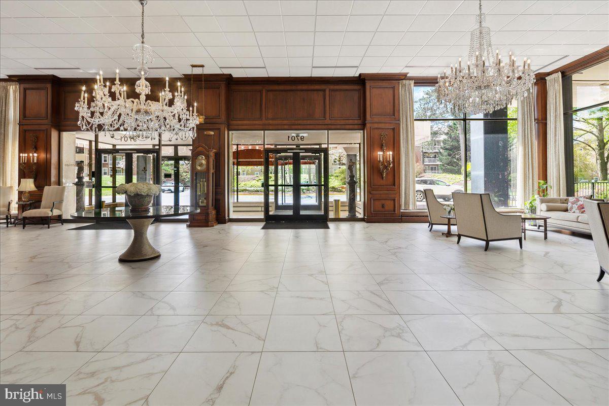 9701 Fields Road, Unit 1808 Gaithersburg, MD 20878 - Photo 7 of 11 a lobby with furniture and floor to ceiling window