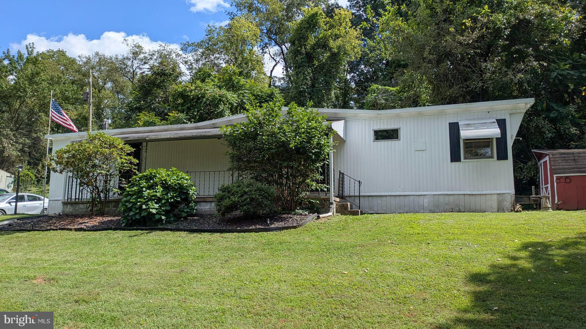 3806 Locust Grove Road Columbia, PA 17512 - Photo 20 of 27 a view of a backyard with potted plants and large trees