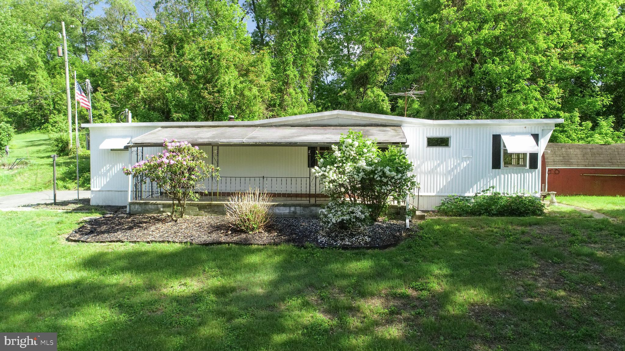 3806 Locust Grove Road Columbia, PA 17512 - Photo 2 of 27 a view of a backyard with plants and a fountain