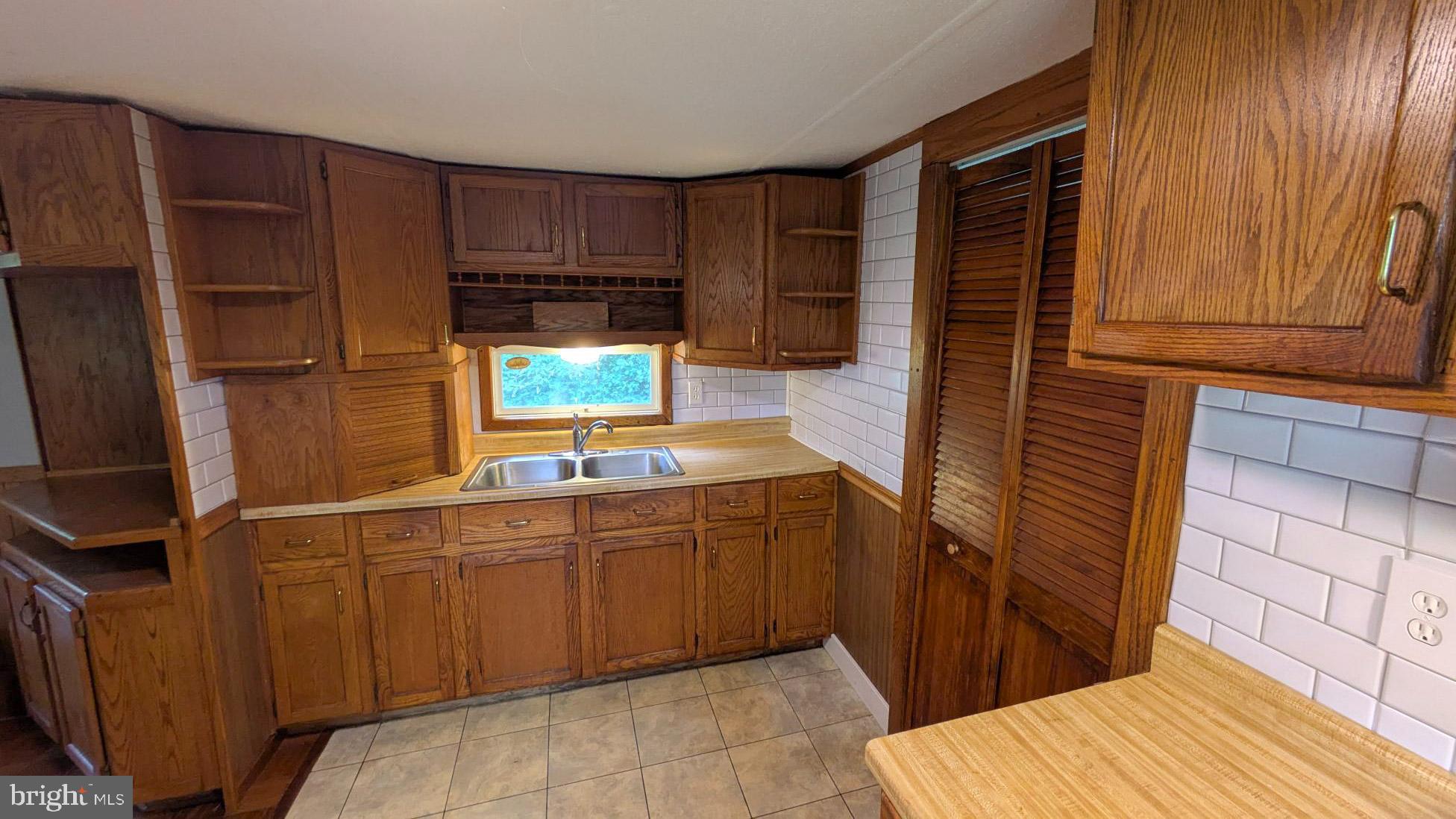 3806 Locust Grove Road Columbia, PA 17512 - Photo 9 of 27 a kitchen with a sink and wooden cabinets