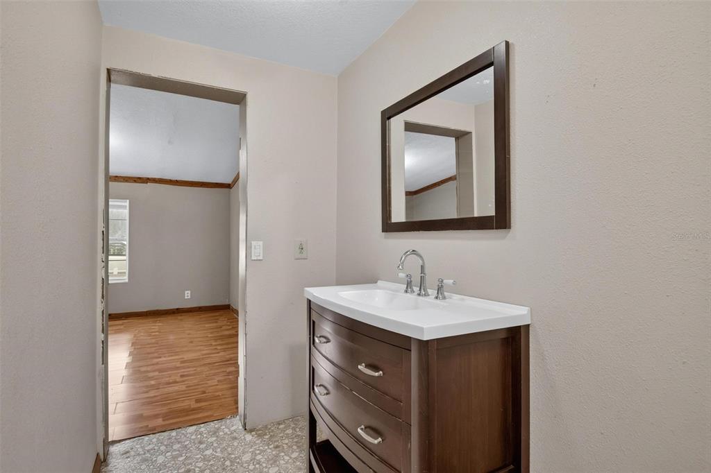 156 Kingfish Road Pomona Park, FL 32181 - Photo 24 of 55 a bathroom with a sink a vanity and a mirror