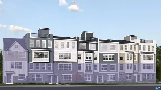 a front view of a residential apartment building with a yard