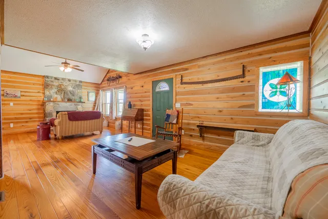 a view of a porch with wooden floor and furniture