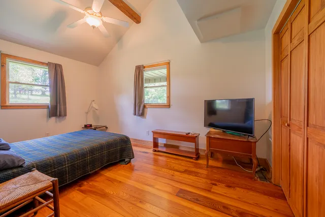 a view of a livingroom with furniture and a flat screen tv