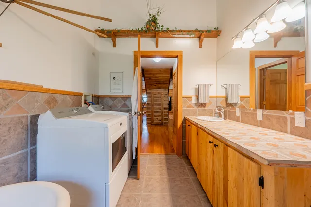 a front view of a house with a yard and trees