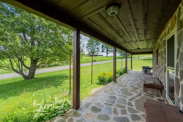 a kitchen with stainless steel appliances granite countertop wooden floors and view living room