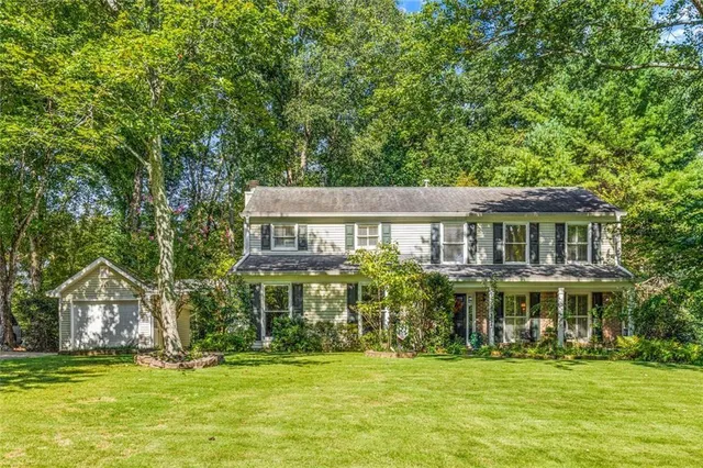 a front view of a house with a garden