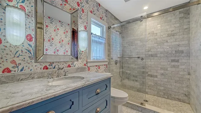 a view of a balcony with chairs and potted plants