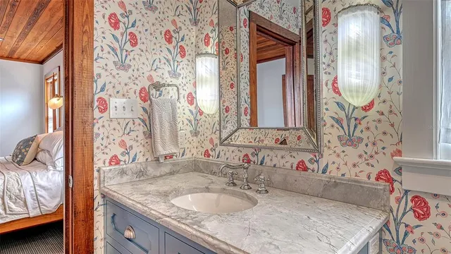 a bathroom with a sink a toilet and a mirror