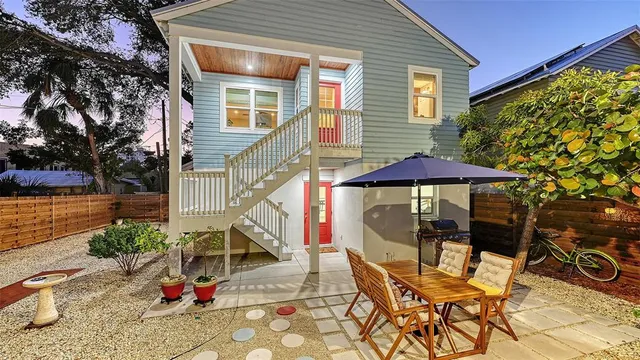 a kitchen with stainless steel appliances a sink and a stove top oven with wooden floor
