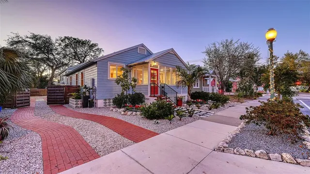 a view of a house with backyard and sitting area