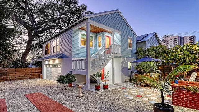a view of a house with backyard and sitting area