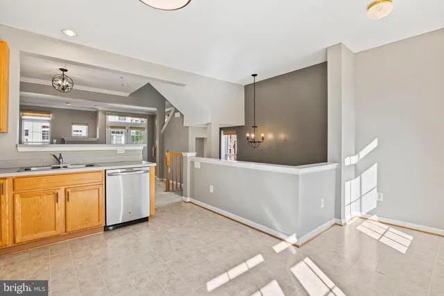 a large white room with a large window and stainless steel appliances