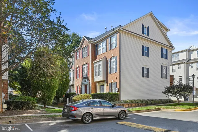 a car parked in front of a white house