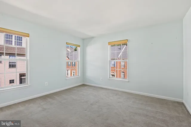 a view of an empty room with windows