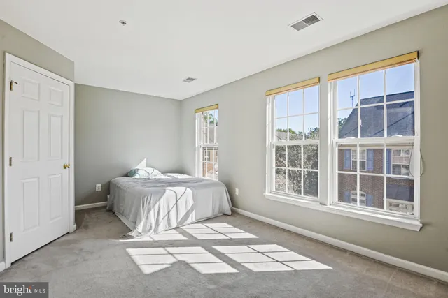 a spacious bedroom with a bed and window
