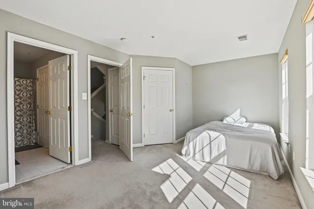 a bedroom with a bed and a mirror