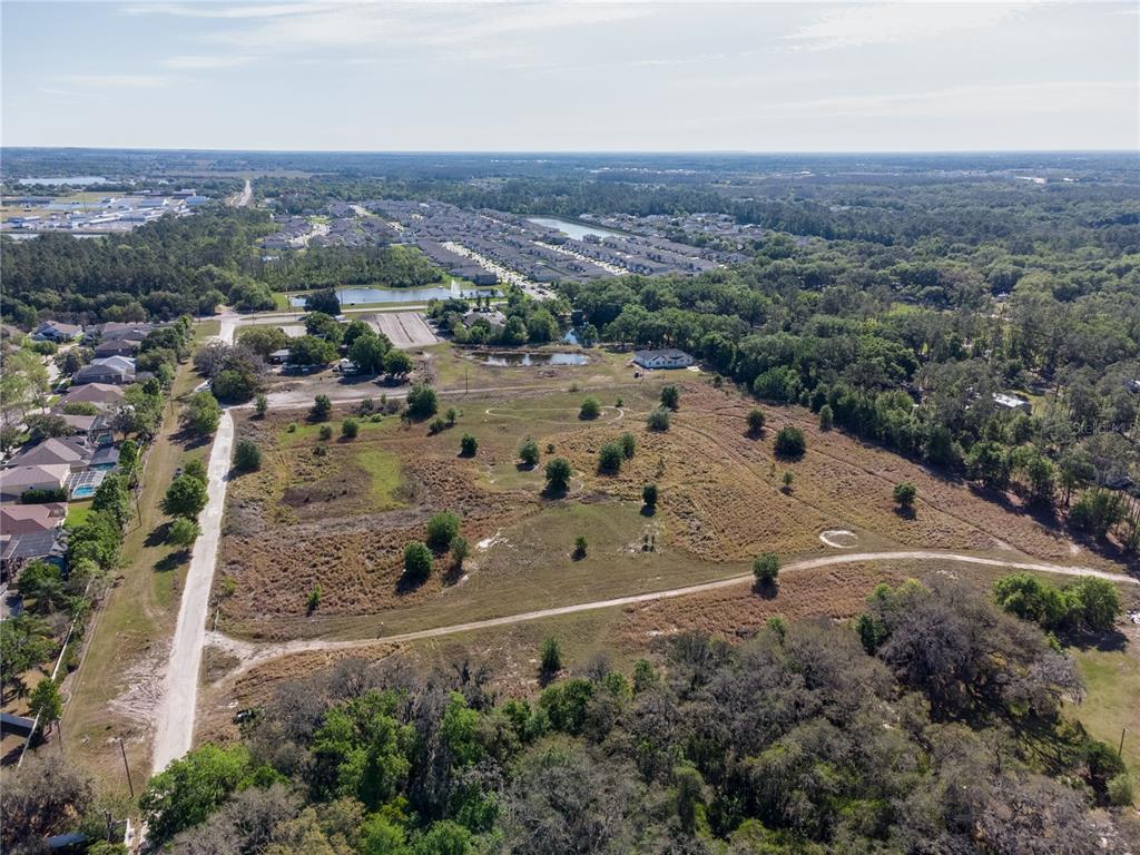 Wells Wesley Chapel, FL 33545 - Photo 4 of 9 an aerial view of multiple house