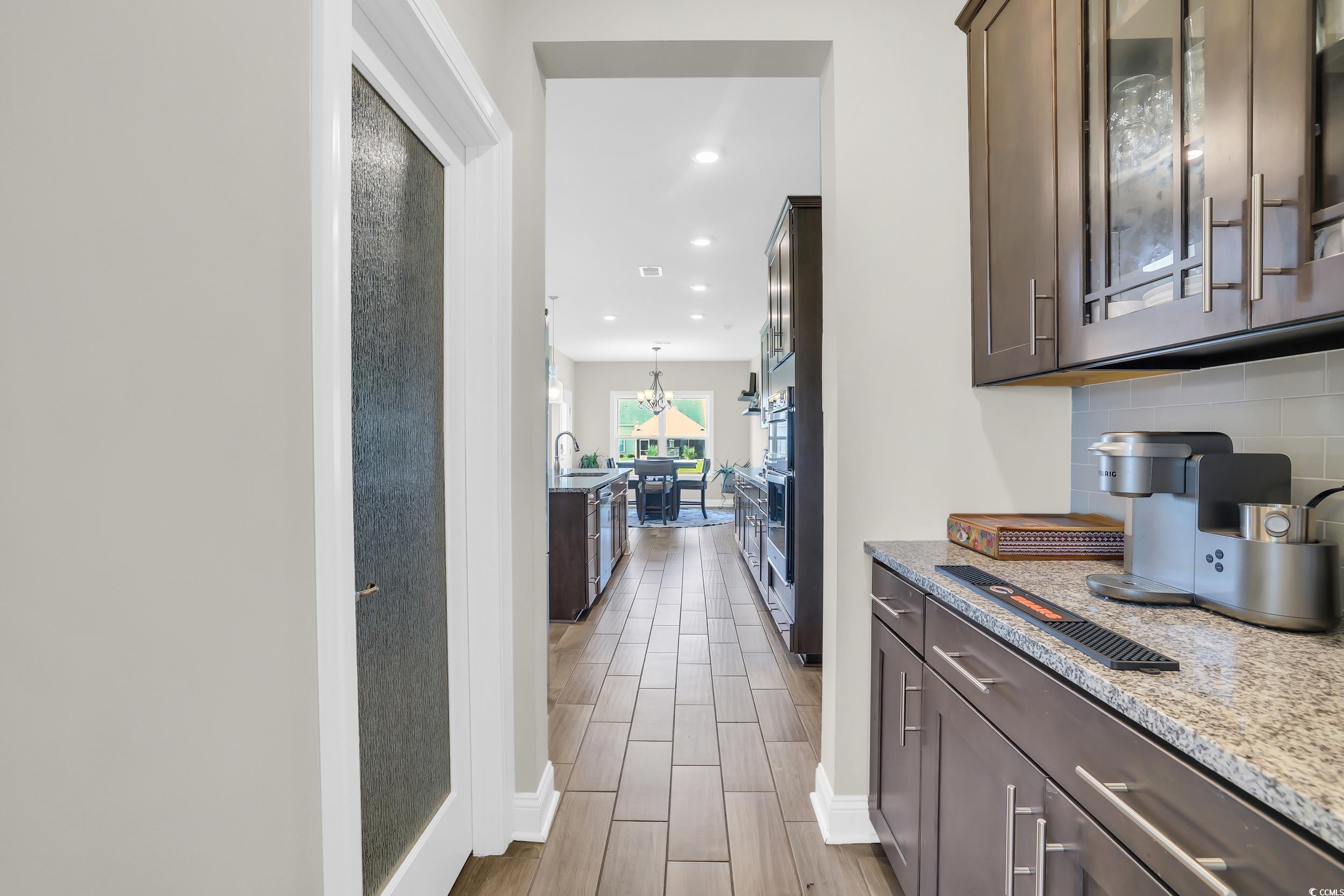 259 Hull Street Surfside Beach, SC 29575 - Photo 11 of 40 Bar featuring tasteful backsplash, wood finish floors, recessed lighting, and a chandelier