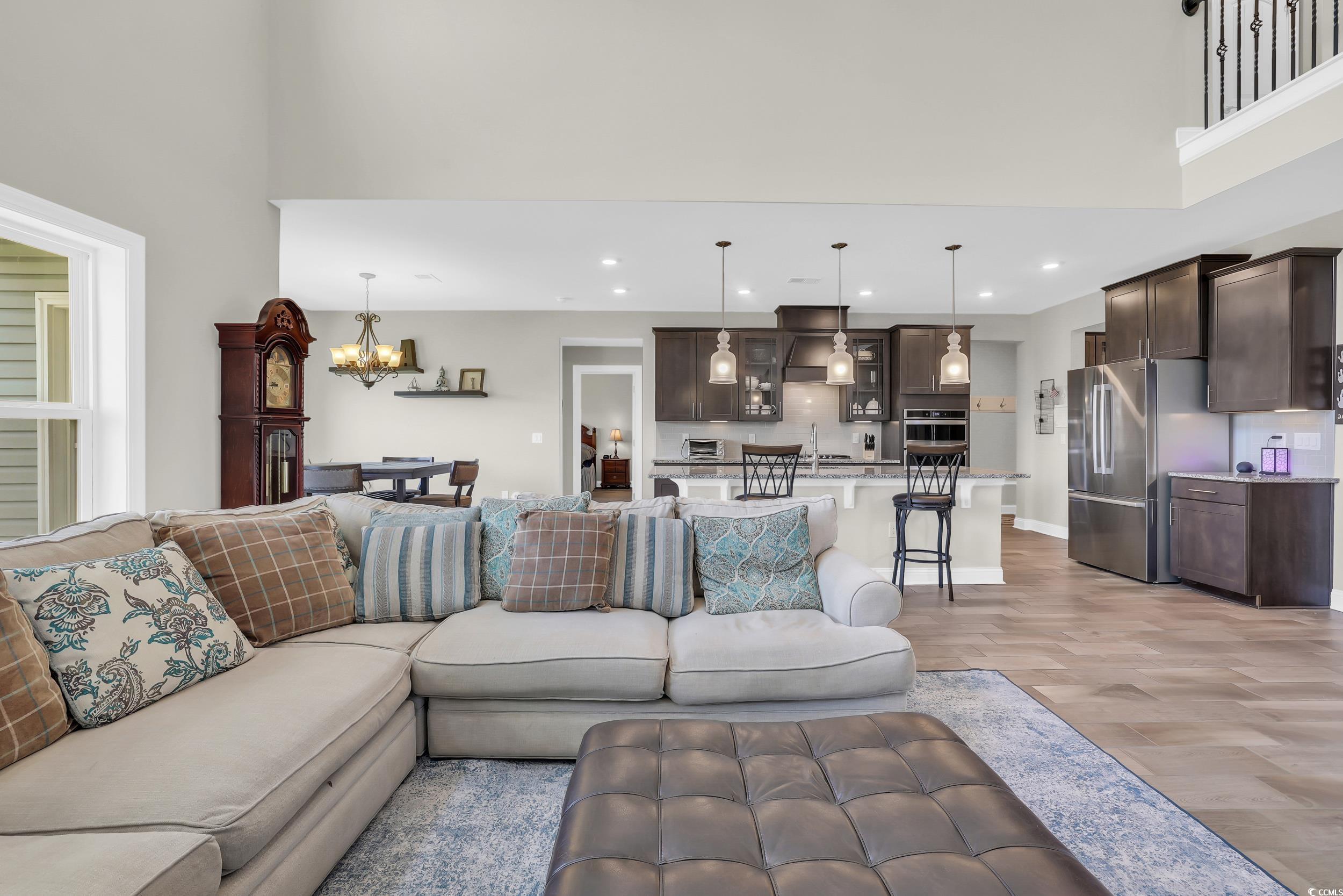 259 Hull Street Surfside Beach, SC 29575 - Photo 17 of 40 Living room with light wood finished floors, recessed lighting, a chandelier, and a towering ceiling