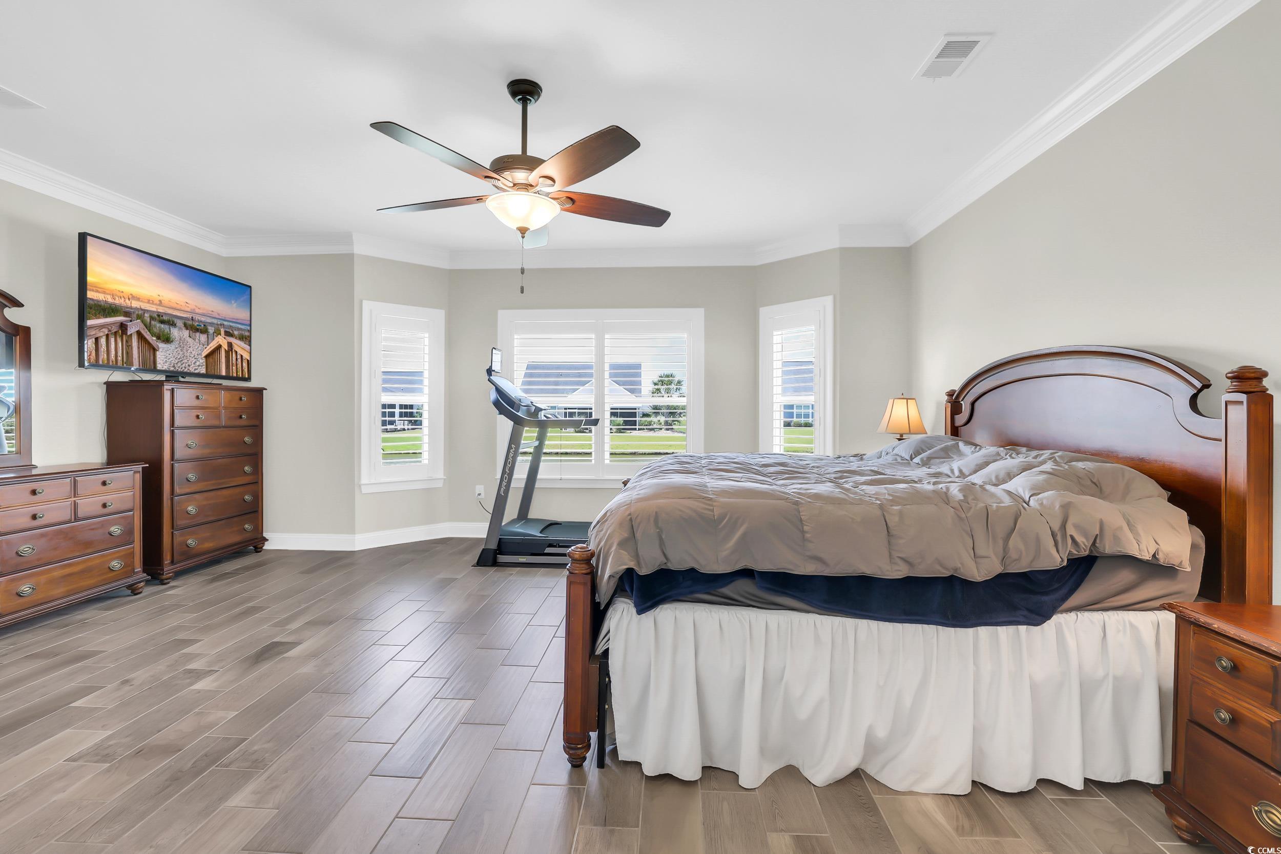 259 Hull Street Surfside Beach, SC 29575 - Photo 19 of 40 Bedroom featuring wood finished floors, ornamental molding, and a ceiling fan