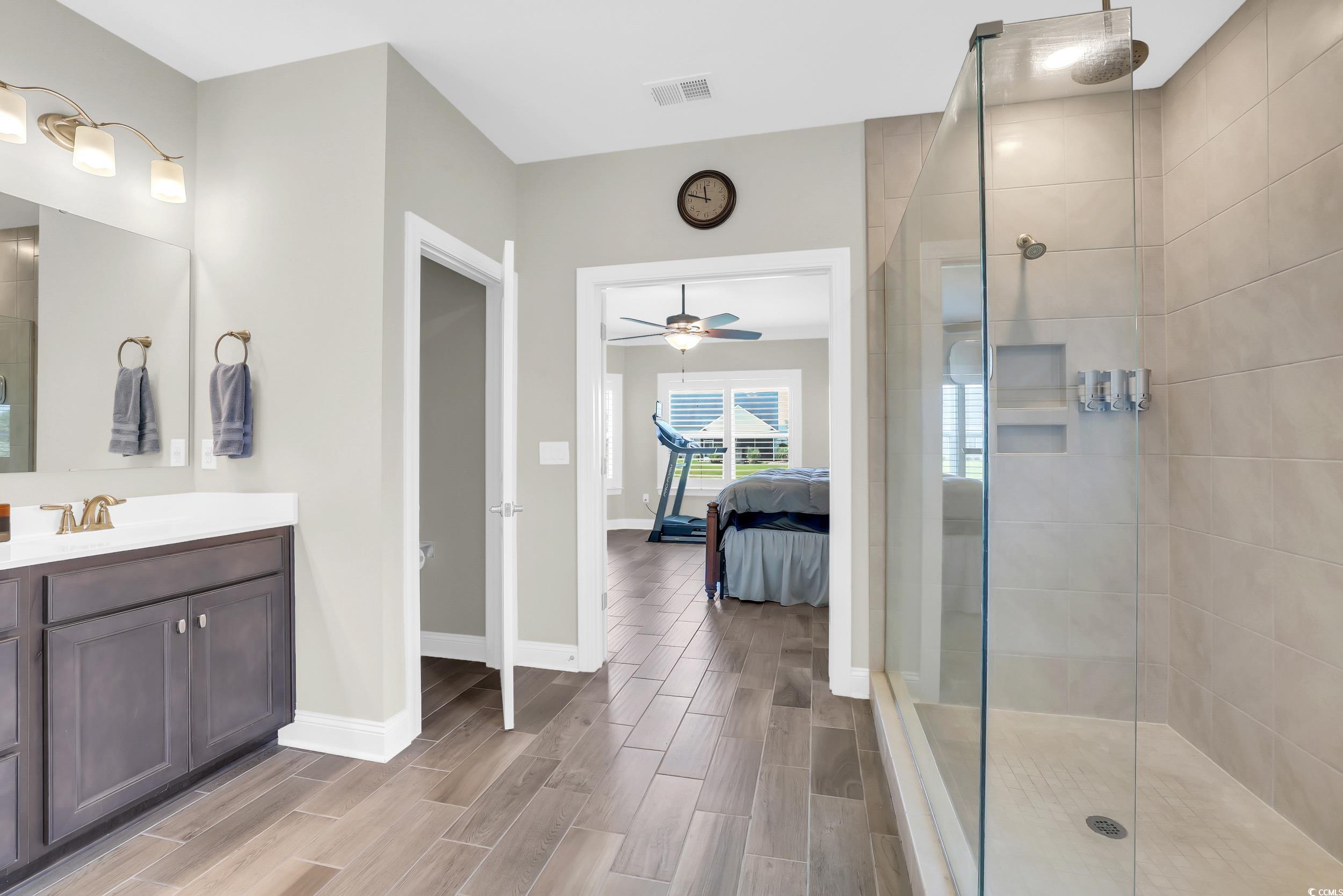 259 Hull Street Surfside Beach, SC 29575 - Photo 20 of 40 Full bath featuring ensuite bath, a walk in shower, vanity, ceiling fan, and wood finished floors