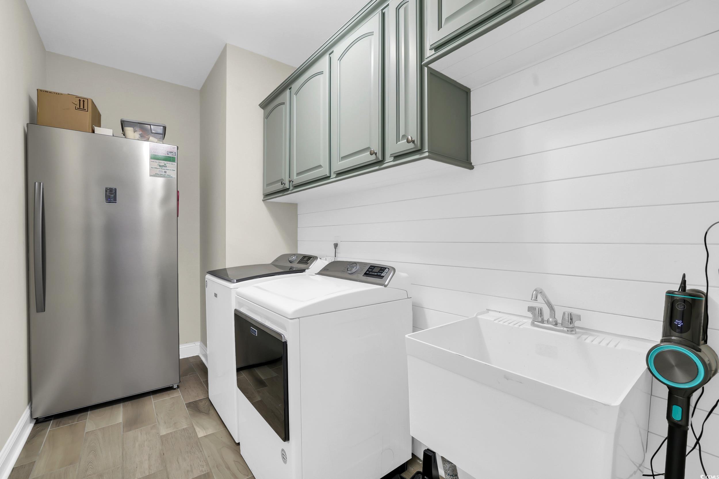 259 Hull Street Surfside Beach, SC 29575 - Photo 22 of 40 Laundry area with separate washer and dryer and cabinet space