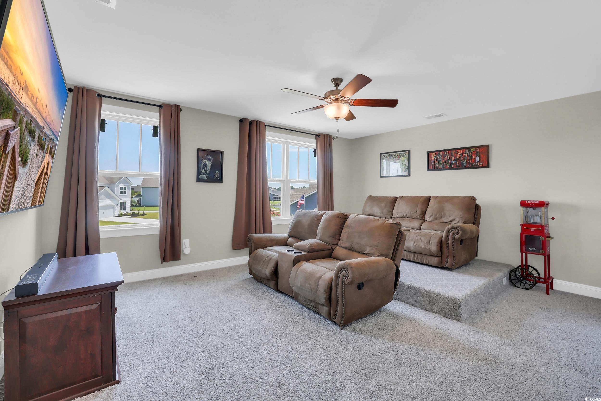 259 Hull Street Surfside Beach, SC 29575 - Photo 23 of 40 Living area with a ceiling fan, plenty of natural light, and carpet flooring
