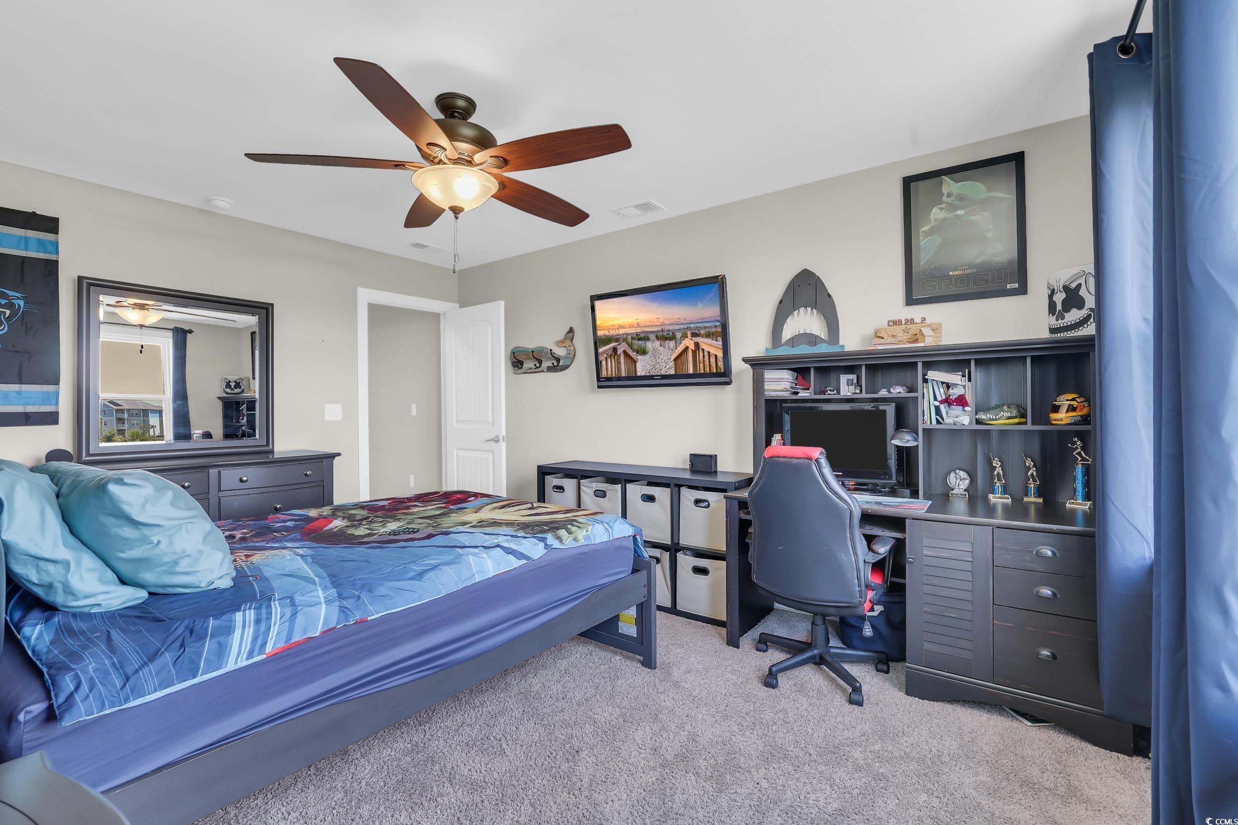 259 Hull Street Surfside Beach, SC 29575 - Photo 29 of 40 Bedroom with carpet floors, a desk, and a ceiling fan