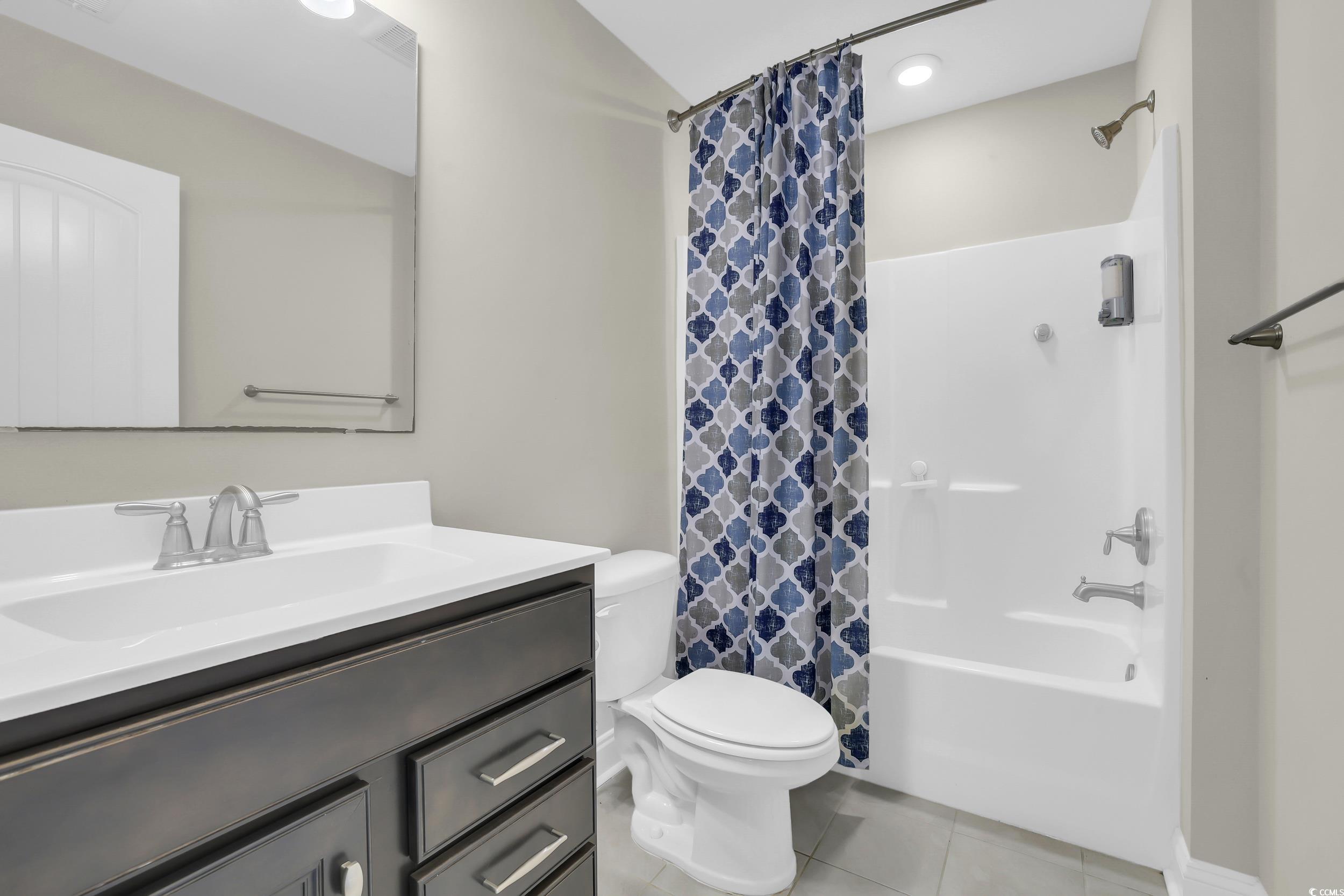 259 Hull Street Surfside Beach, SC 29575 - Photo 32 of 40 Full bathroom featuring tile patterned flooring, vanity, and shower / tub combo
