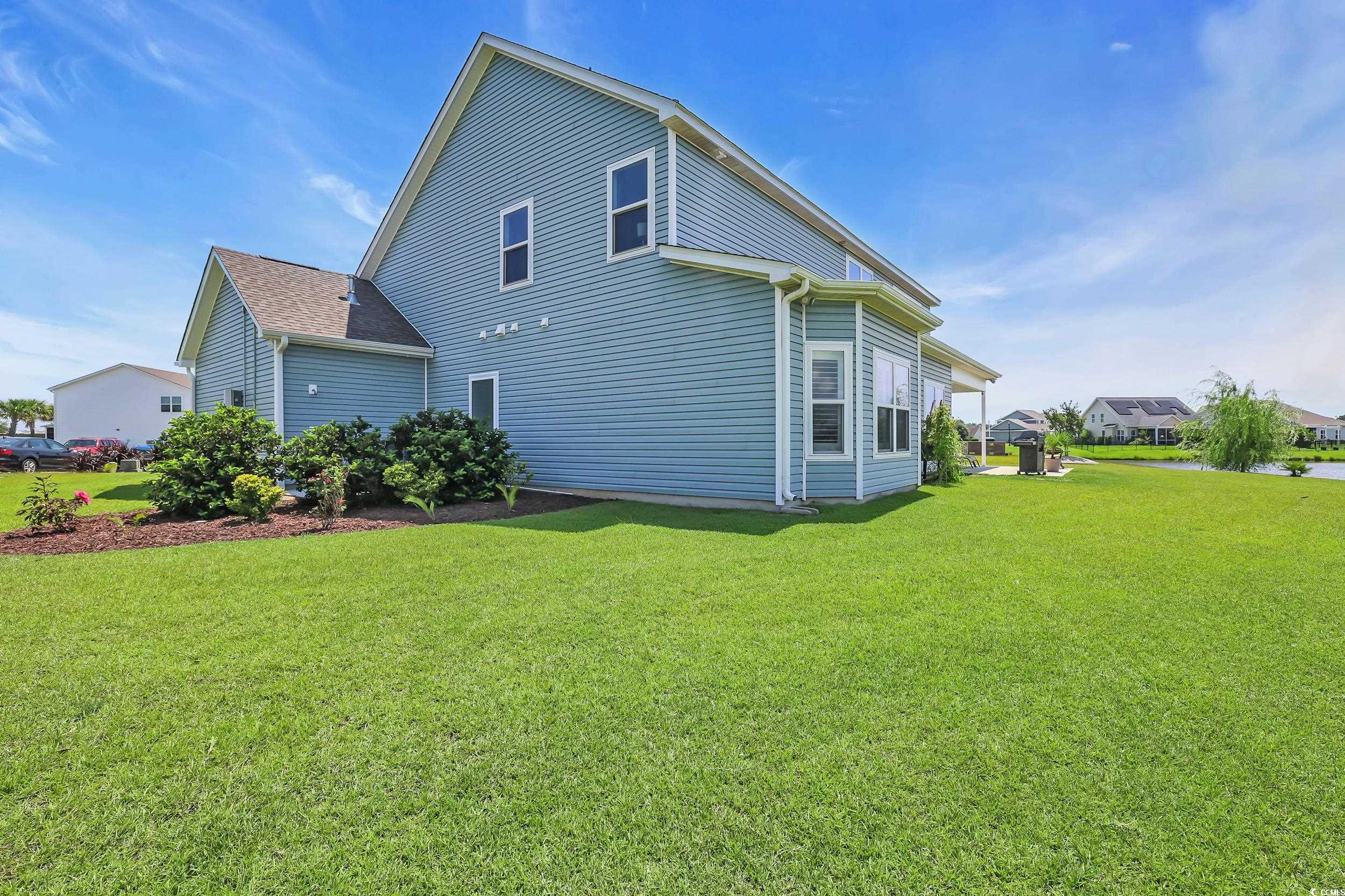 259 Hull Street Surfside Beach, SC 29575 - Photo 33 of 40 Rear view of house with a yard