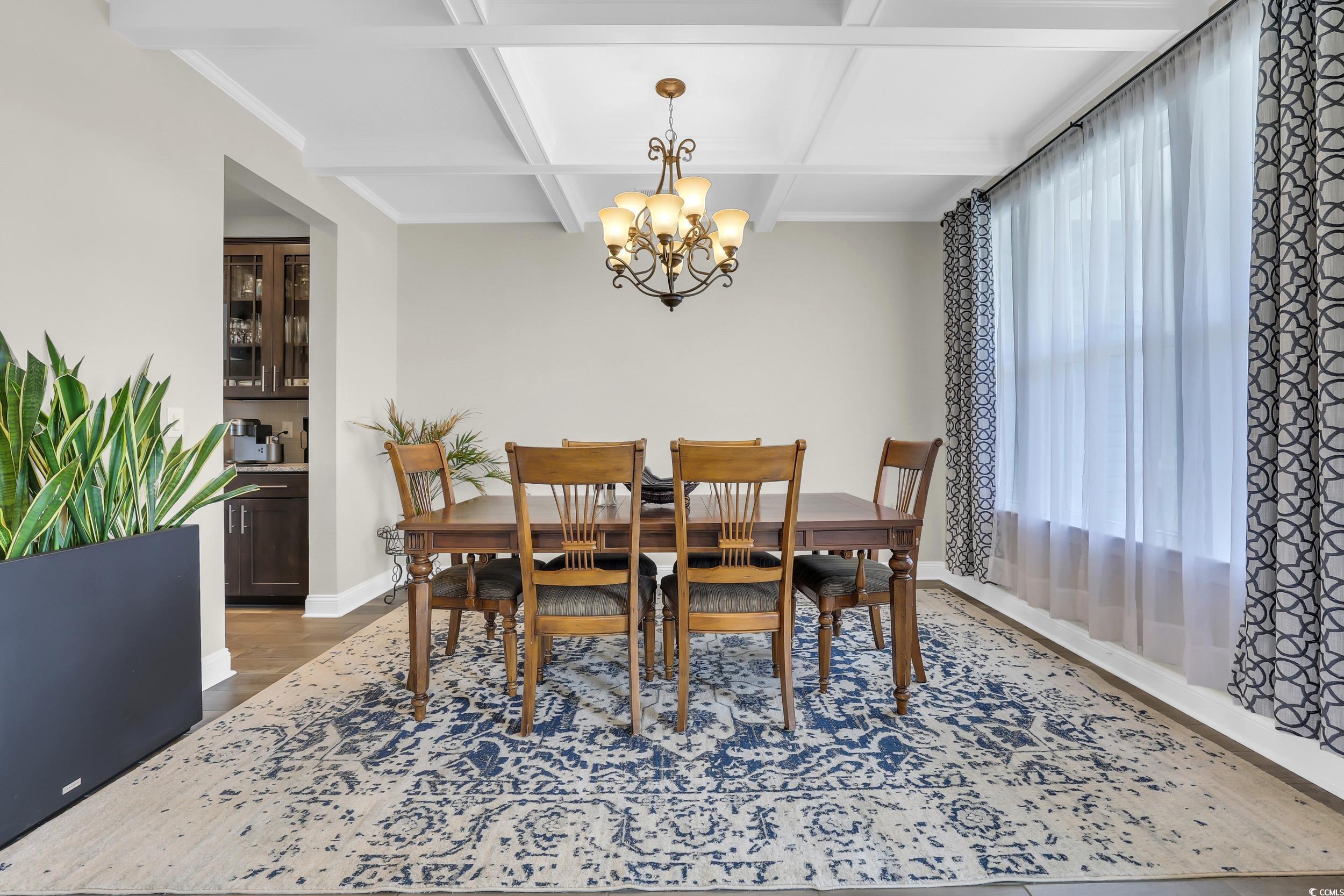259 Hull Street Surfside Beach, SC 29575 - Photo 4 of 40 Dining room with a chandelier, coffered ceiling, wood finished floors, and beamed ceiling
