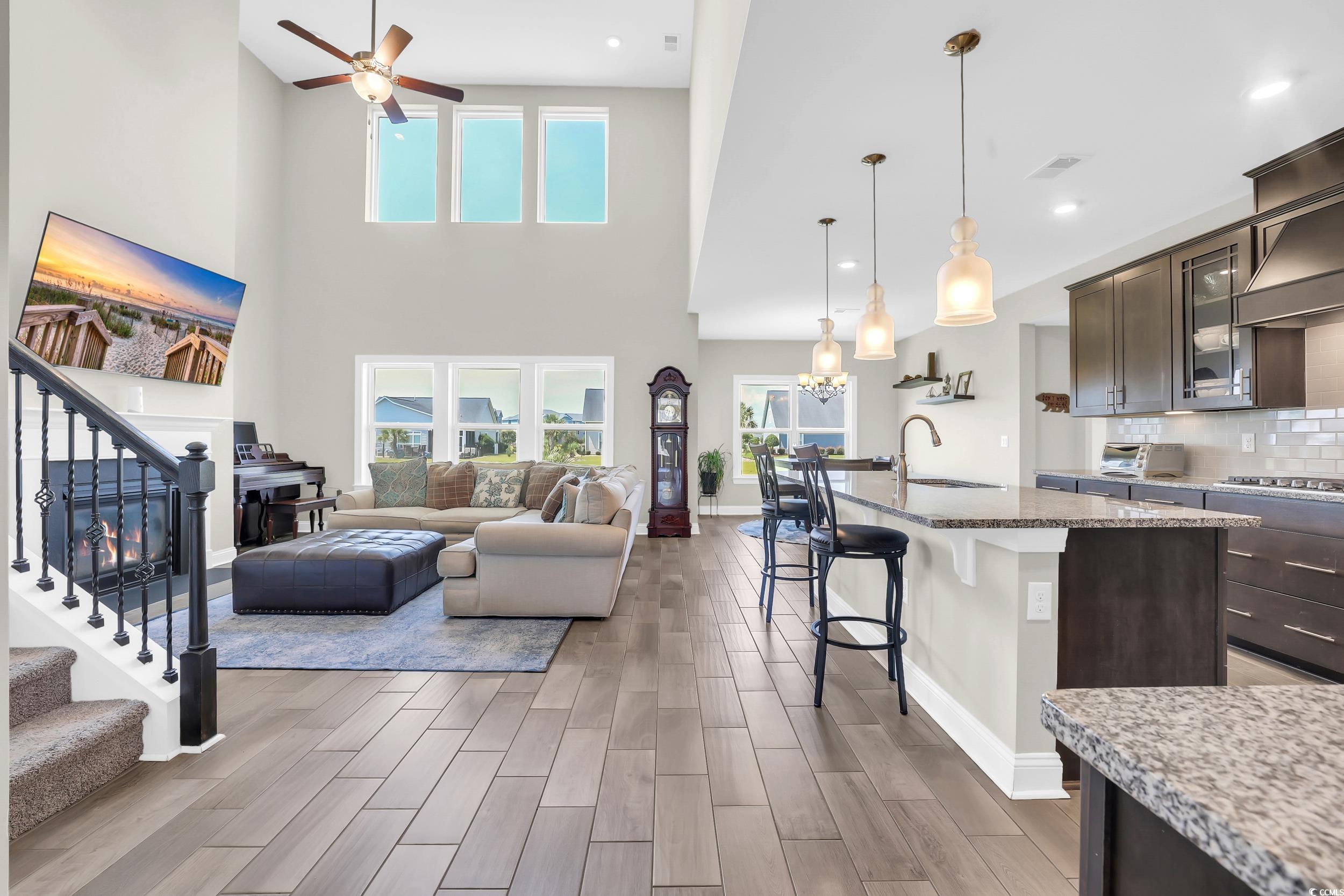 259 Hull Street Surfside Beach, SC 29575 - Photo 6 of 40 Living area featuring ceiling fan, stairway, wood finished floors, a chandelier, and recessed lighting
