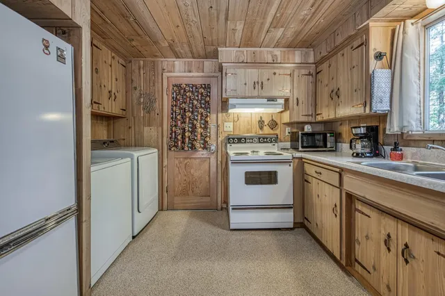 a kitchen with a white cabinets and white appliances