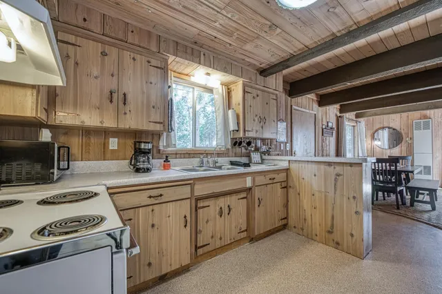 a kitchen with appliances cabinets and a sink