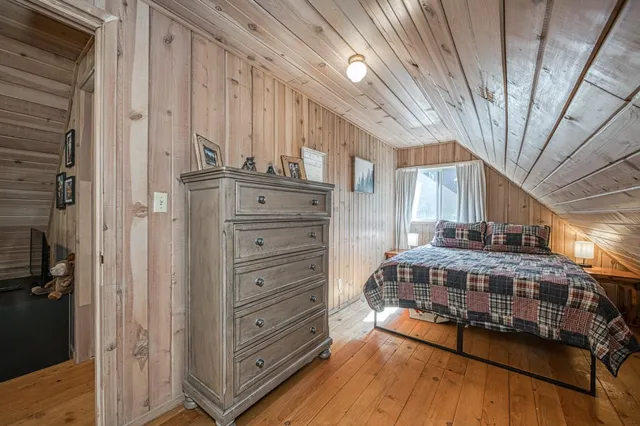 a view of bedroom with a large bed and dresser