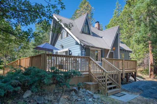 a view of a house with a deck and furniture
